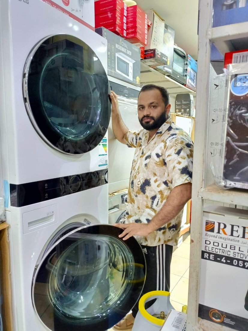 Inspecting a stacked washer and dryer in Jeddah
